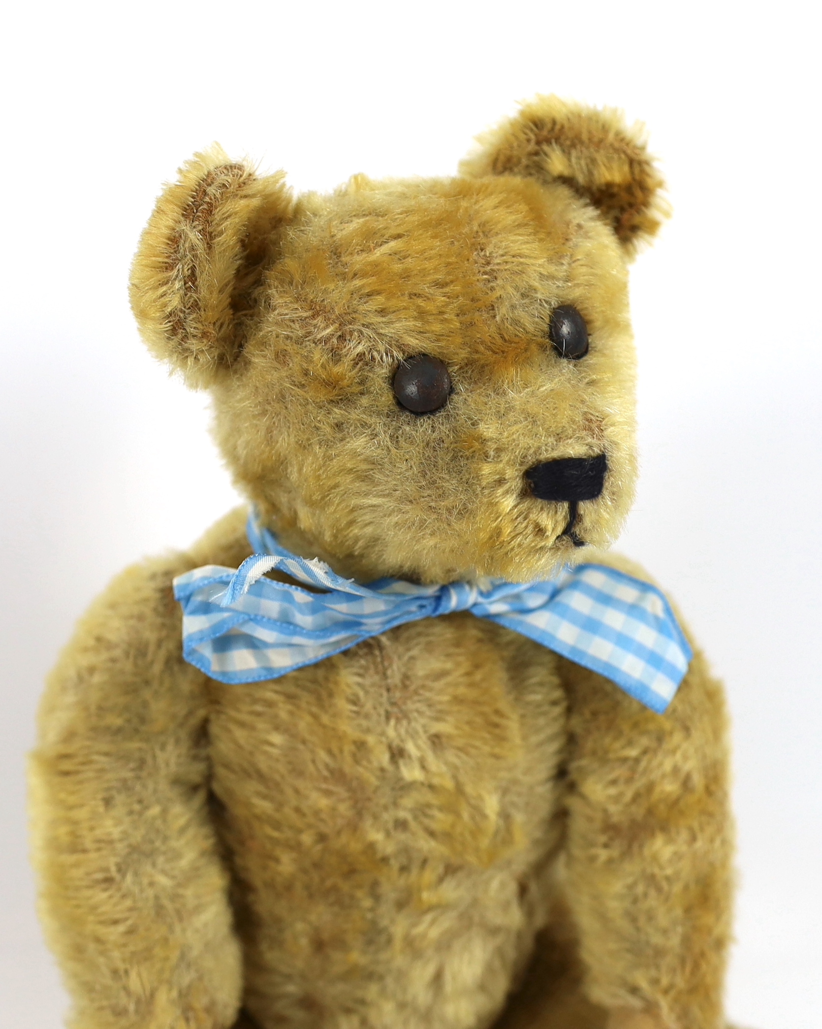 An early German bear, c.1920, with set in ears, black button eyes, 35cm, replaced paw pads, otherwise good condition